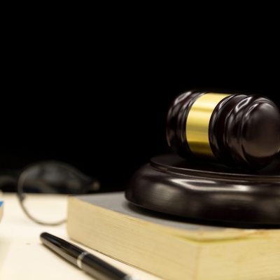 Judges gavel on book and wooden table. Law and justice concept background.